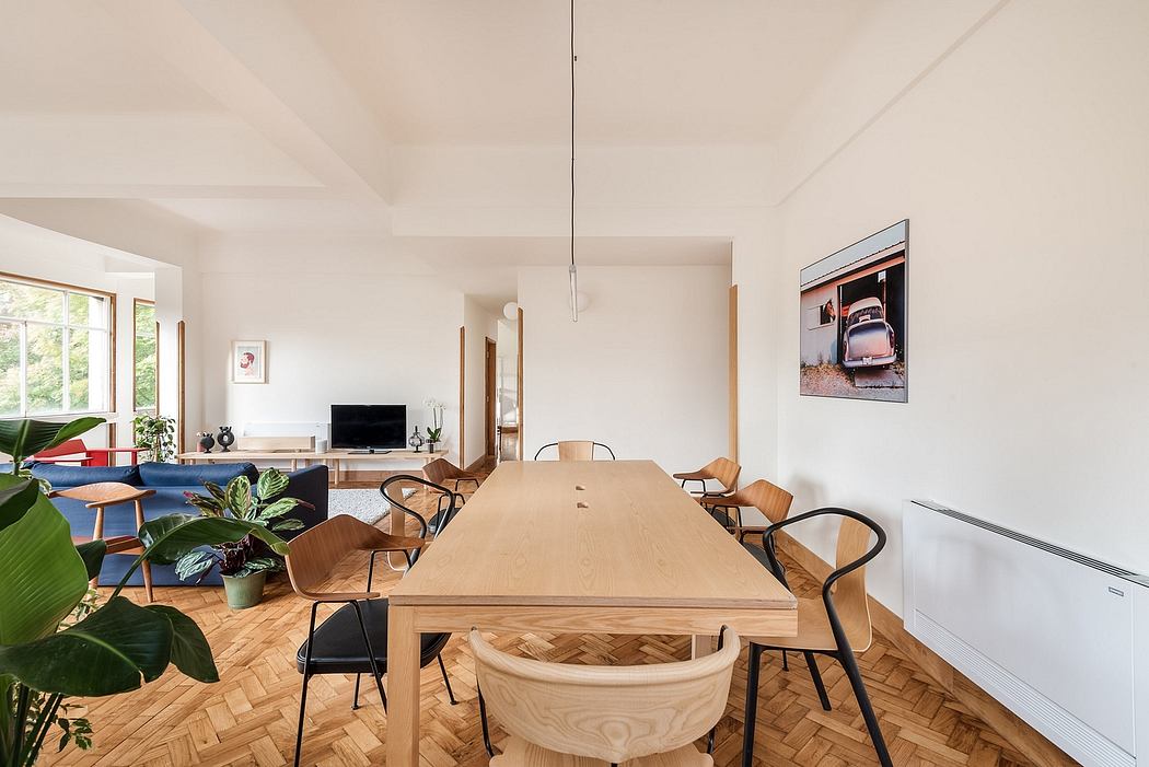 Bright, airy dining room with minimalist decor and herringbone floor.