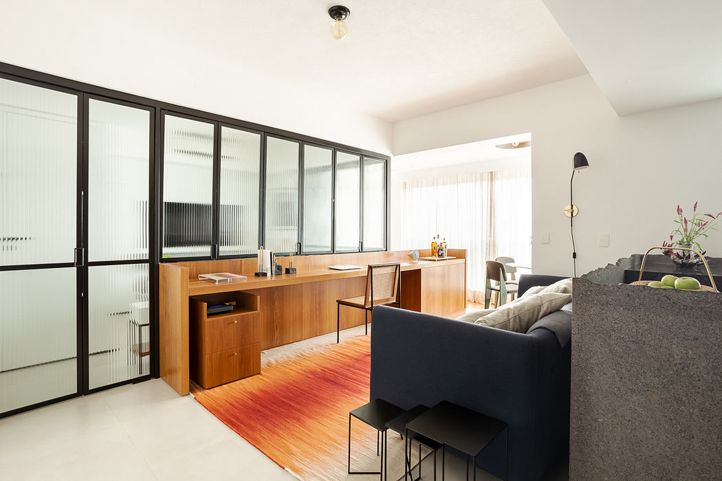 Sleek home office with wooden desk and glass partition.