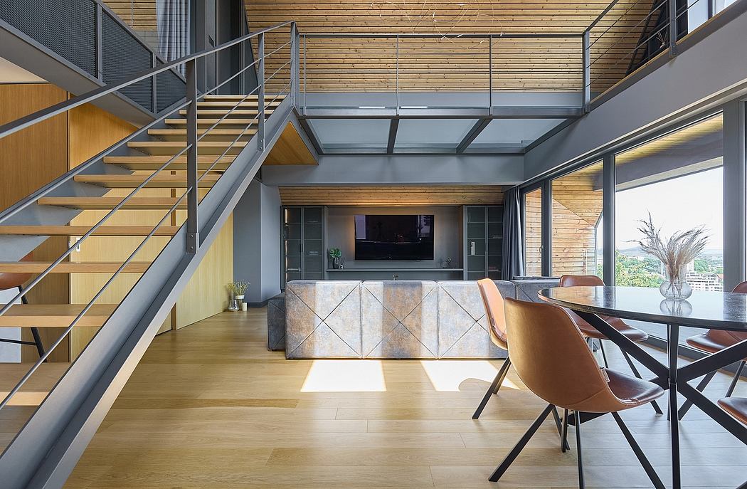 Modern interior with wooden floors, staircase, dining area, and fireplace.