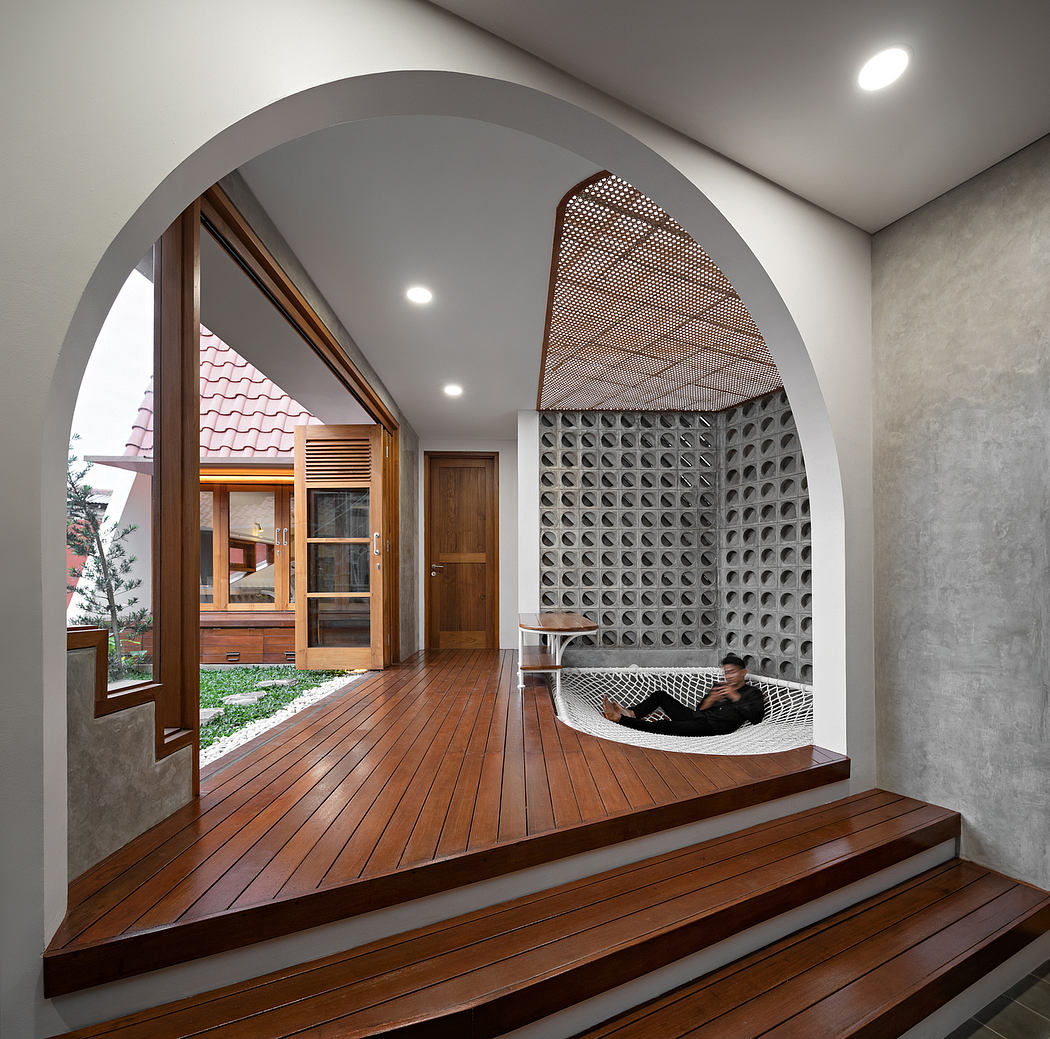 Contemporary home interior with arched doorway, wooden floors, and lattice wall no