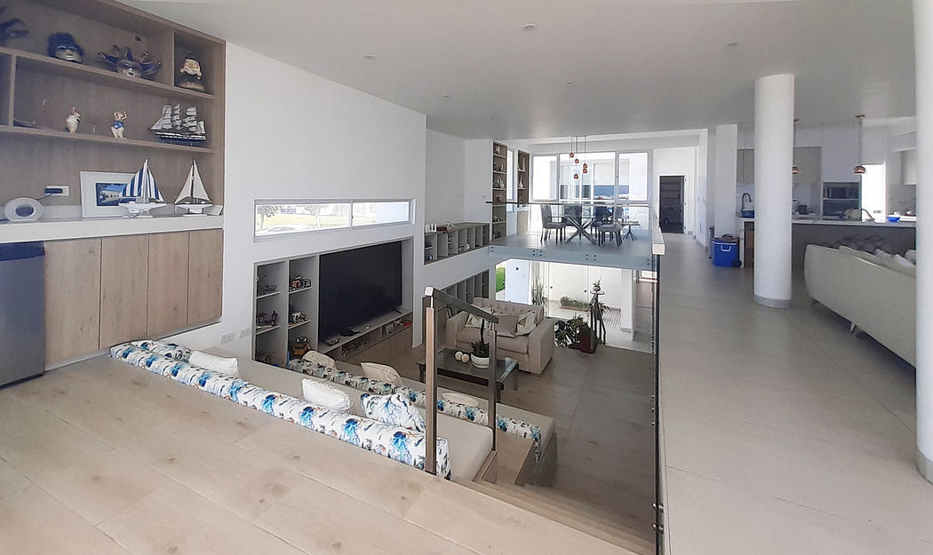 Spacious interior with sleek design, open plan living area, and minimalistic decor