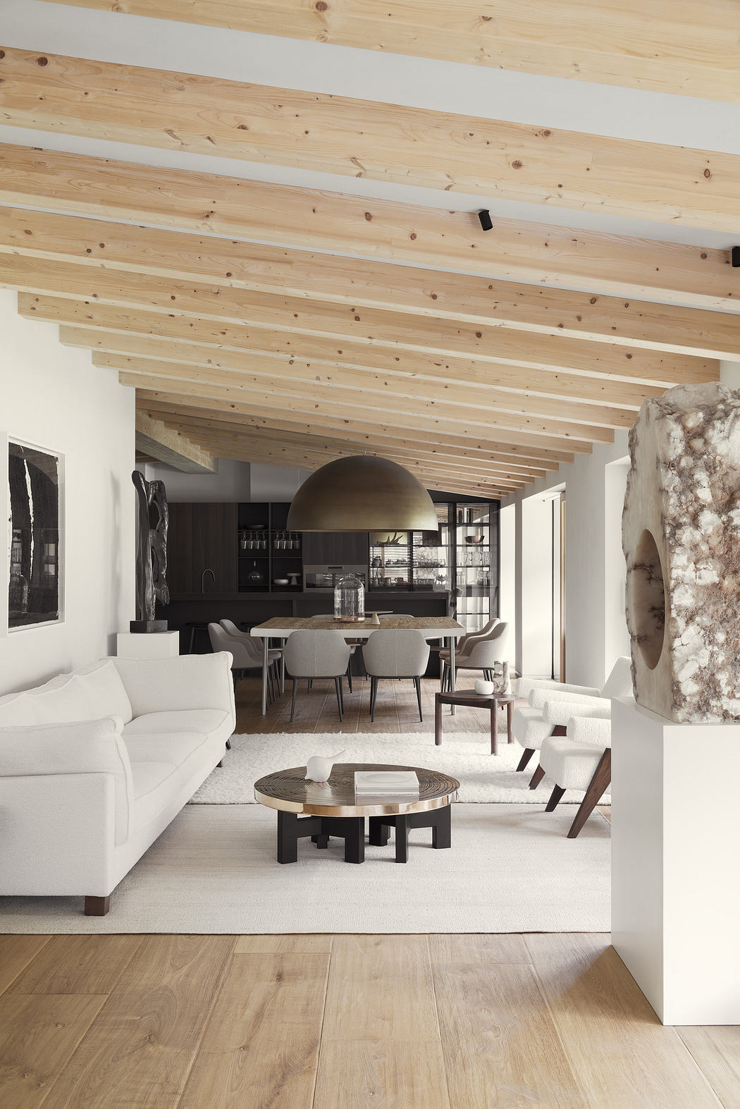 Modern living room with exposed wooden beams, white sofas, and minimalist decor.