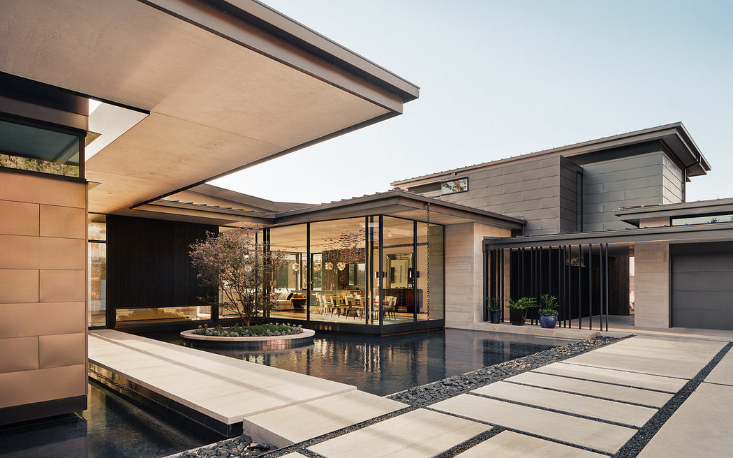 Modern house with clean lines, expansive windows, and a courtyard.