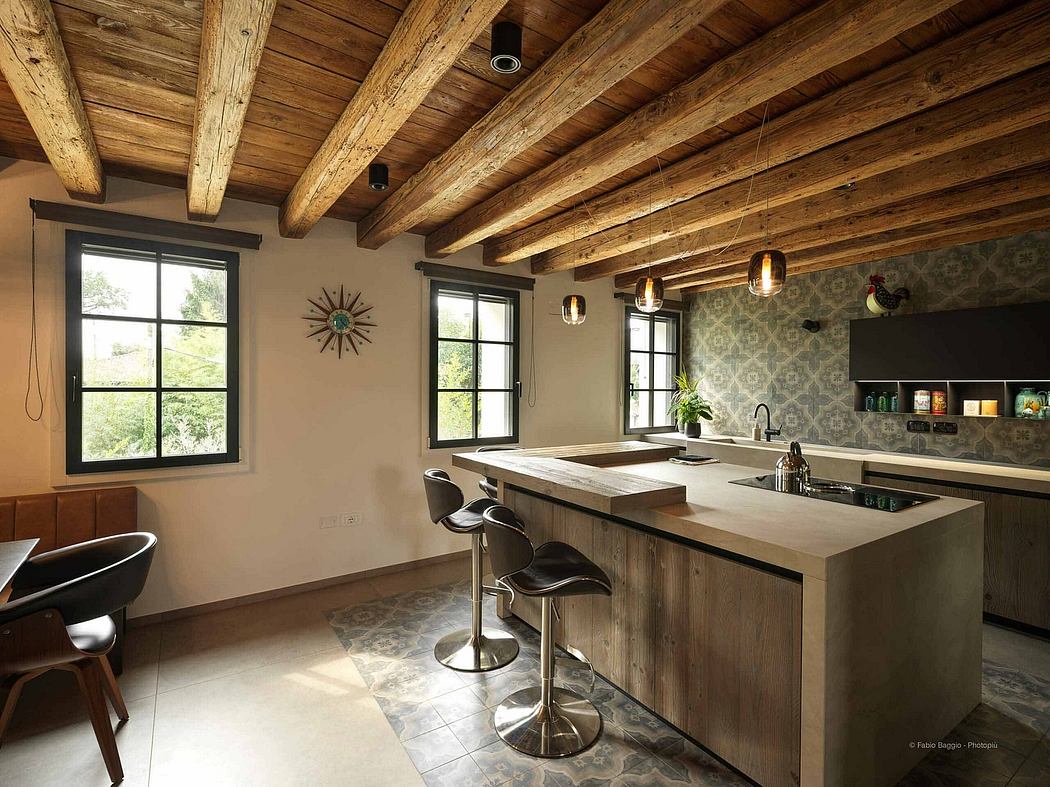 Rustic kitchen with wooden beams and a central island.