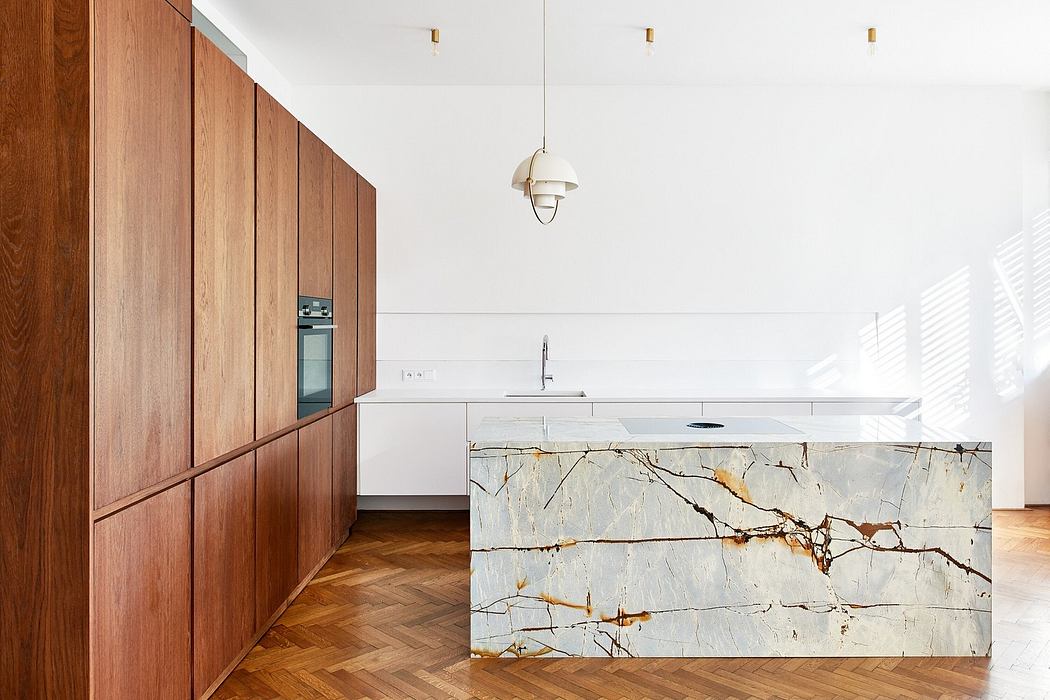Contemporary kitchen with marble island and wooden cabinets.