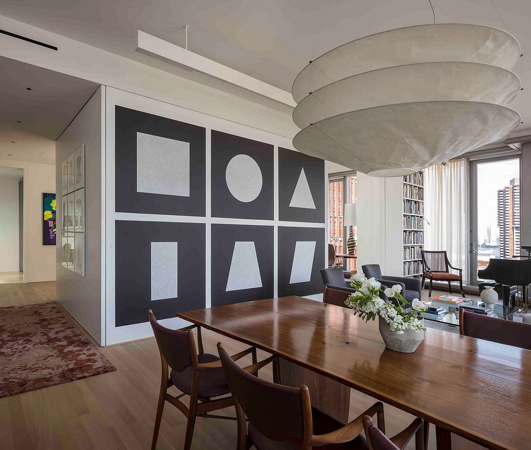 Contemporary dining room with geometric wall art and circular pendant light.