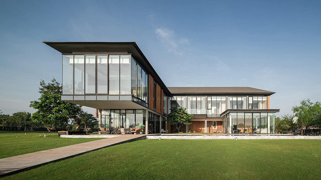 Contemporary two-story glass-walled building with cantilevered design surrounded by