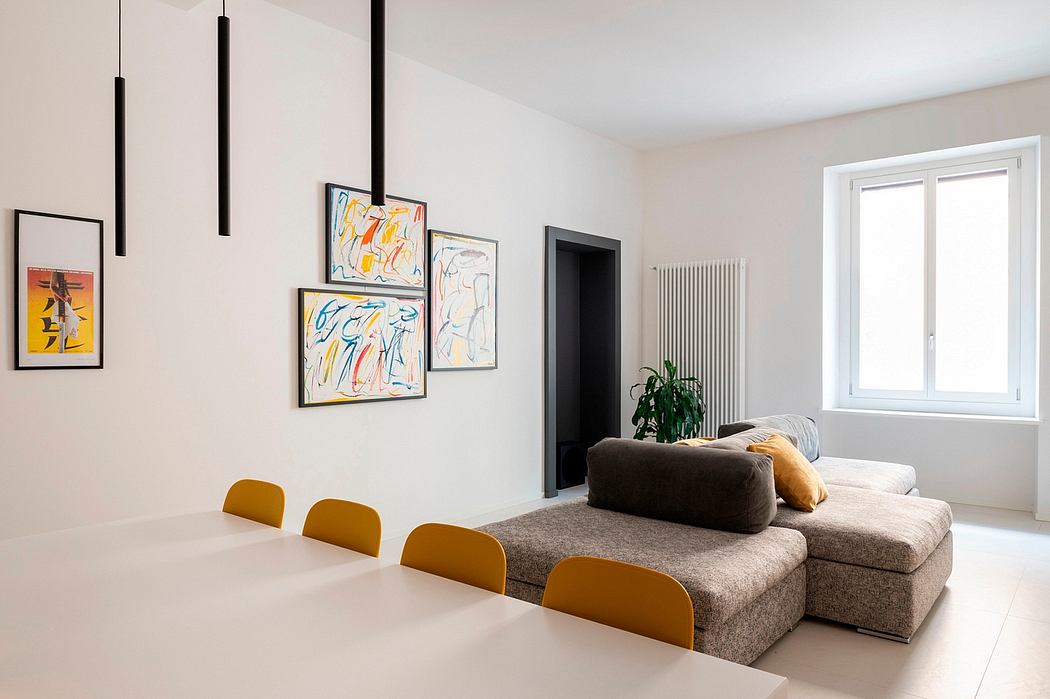 Modern living room with art, pendant lights, and sectional sofa.