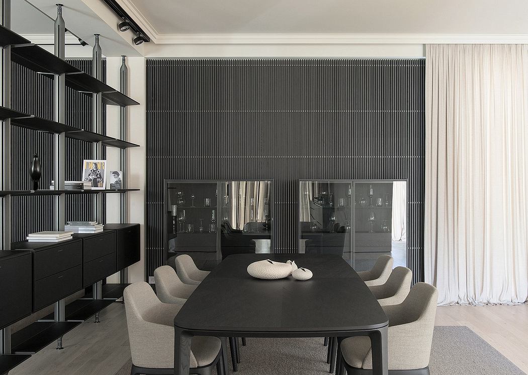 Modern dining room with black table, gray chairs, and dark shelving unit.