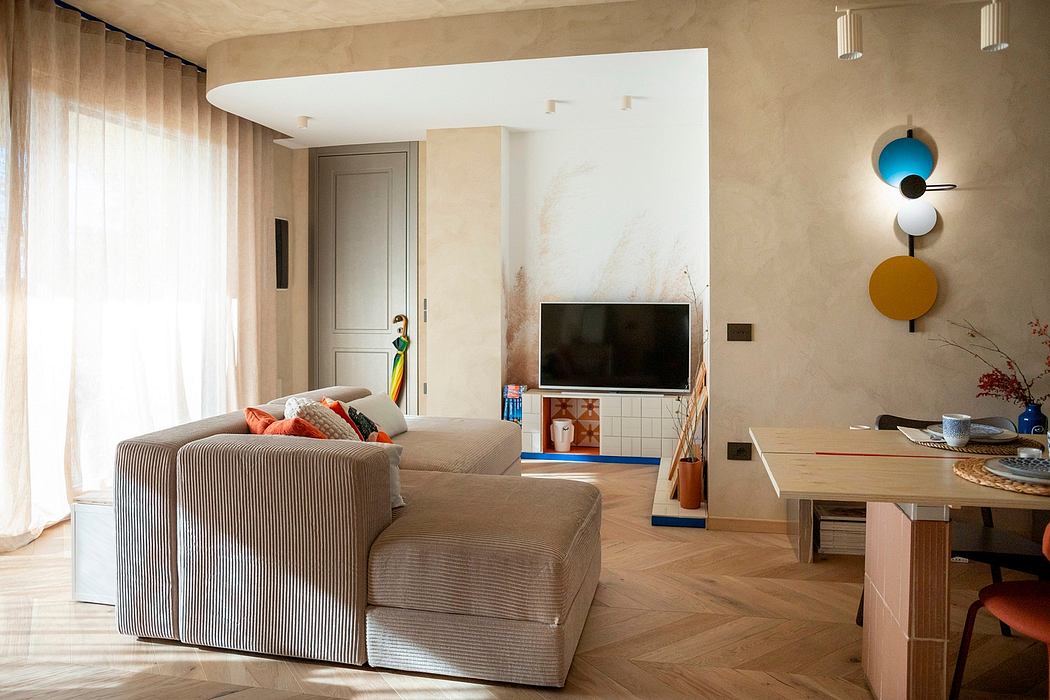 Modern living room with sofa, TV, and artistic wall decor.