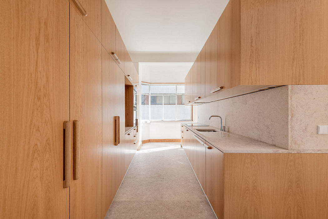 Modern kitchen with wooden cabinets and a stone countertop.
