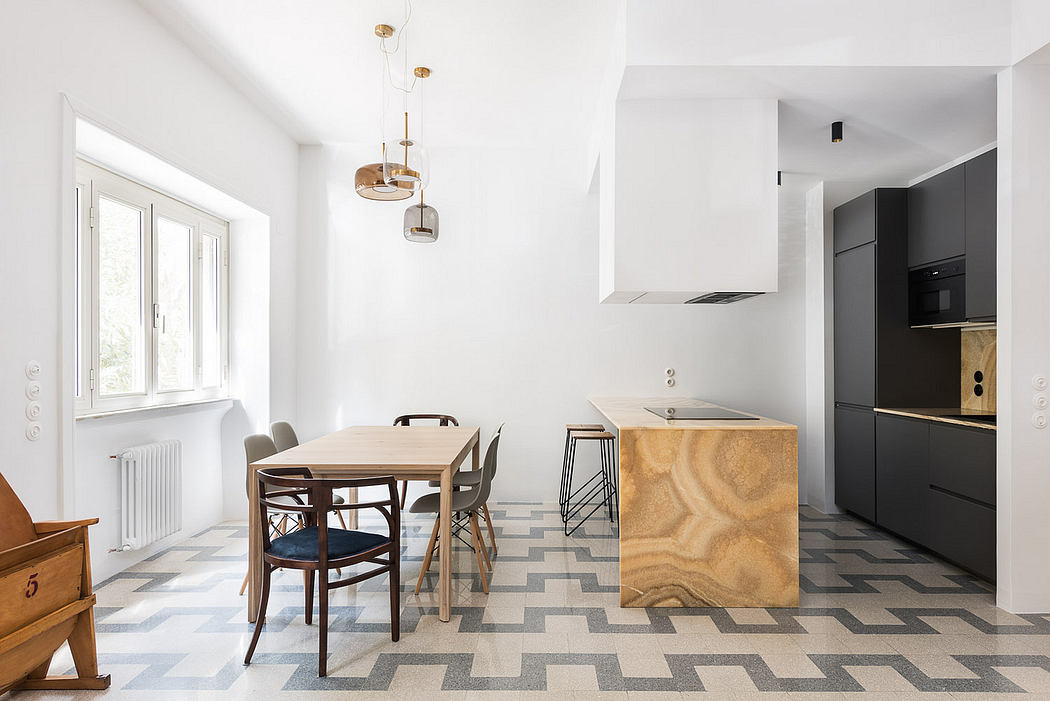 Modern kitchen with geometric floor and wooden dining table.