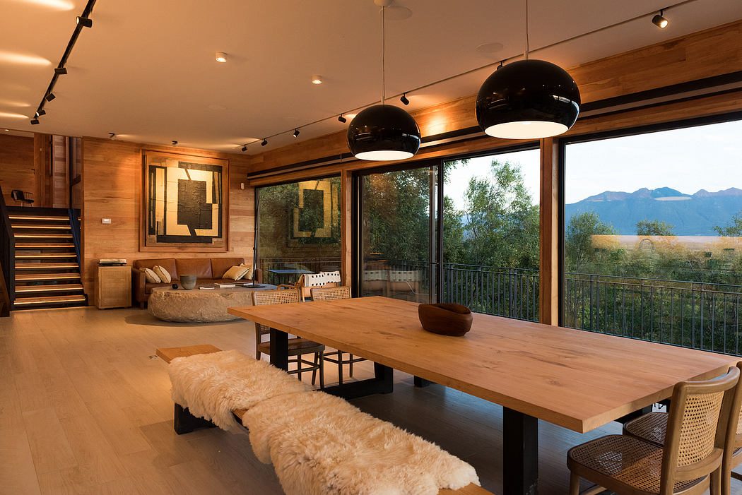 Contemporary wooden interior with large windows and pendant lights.