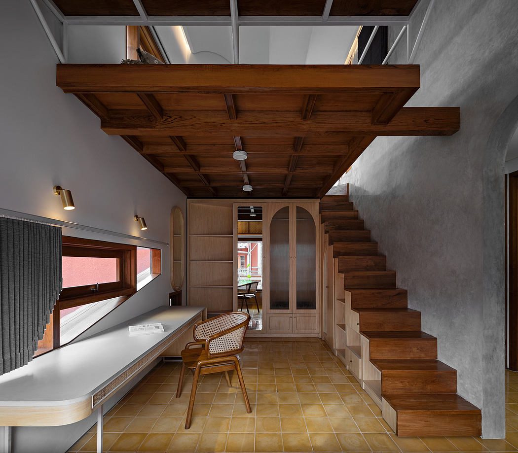 Contemporary interior with wooden accents, mezzanine floor, and floating staircase.