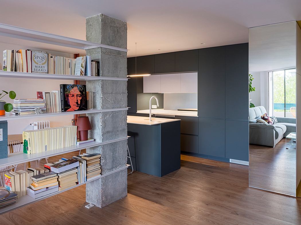 Modern kitchen interior with bookshelf and living room view.