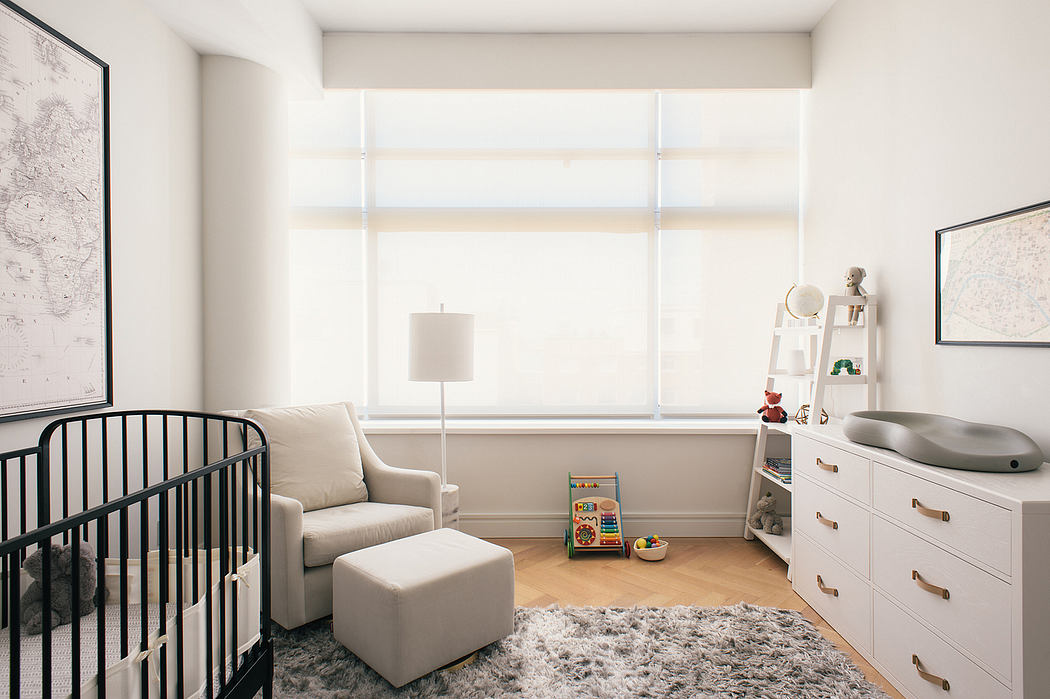 Minimalist nursery room with a crib, armchair, and soft colors.