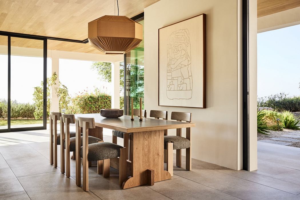 Modern dining room with wooden table, chairs, and pendant light.