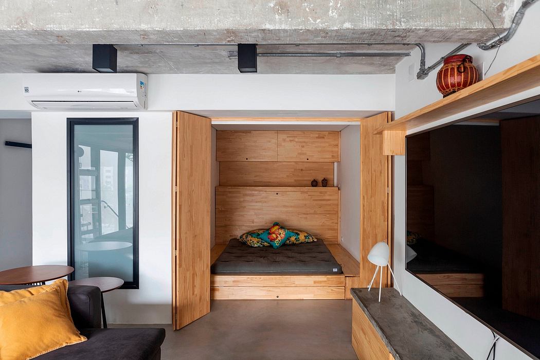 Modern room with a built-in wooden bed nook and minimalist decor.