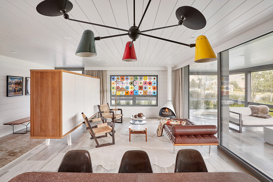 Modern living room with colorful pendant lights and mid-century furniture.