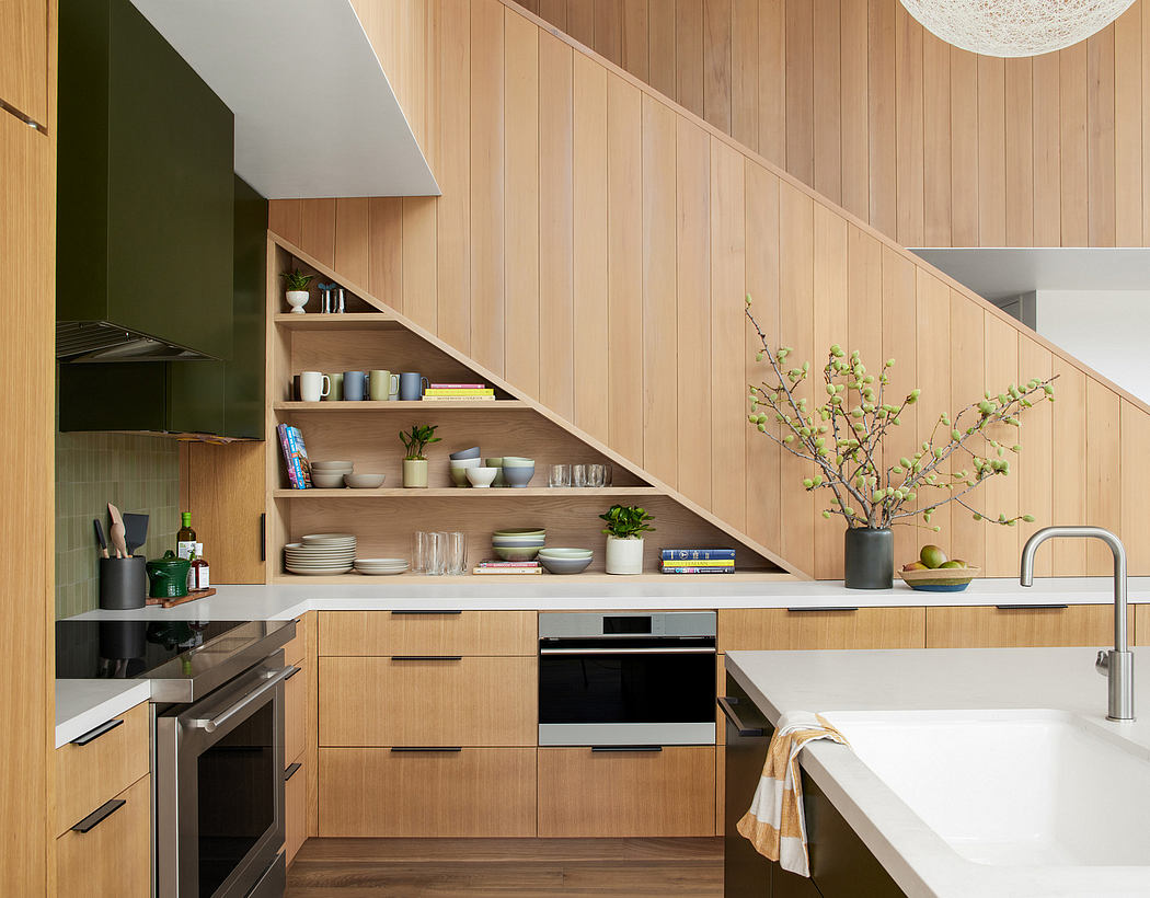 Modern kitchen interior with wood finish and integrated appliances.