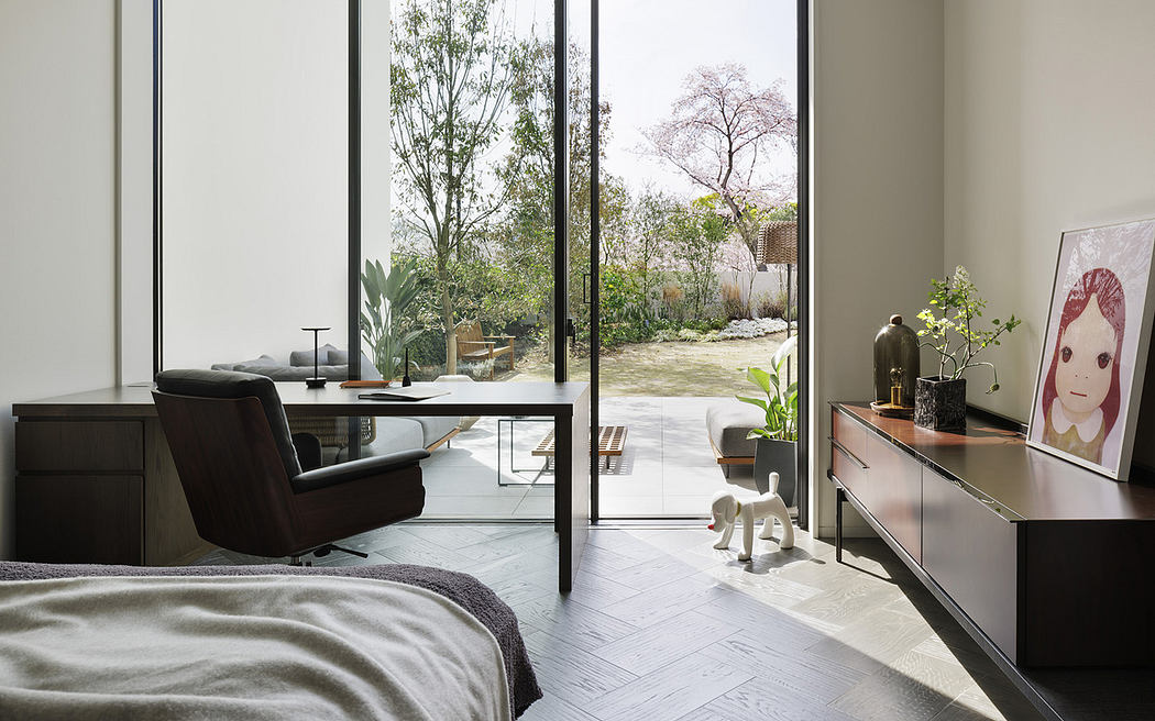Minimalist bedroom with sleek furniture and garden view.
