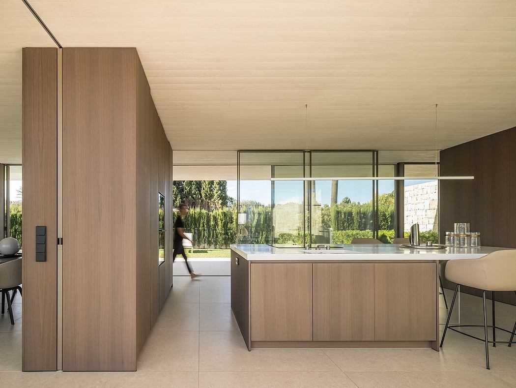 Modern kitchen interior with large windows and minimalistic design.