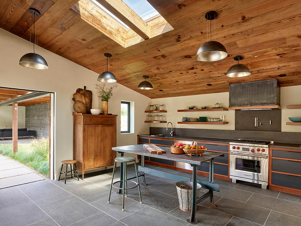 Modern kitchen with wooden ceiling, island, and pendant lights.