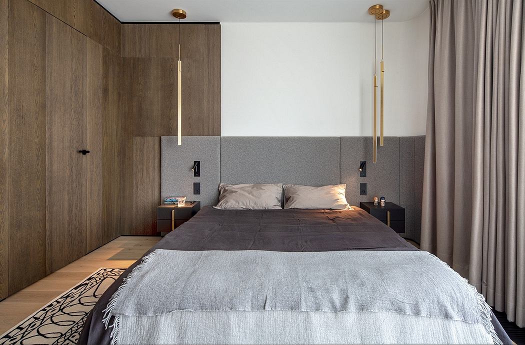 Modern bedroom with wooden panels and grey bedding.