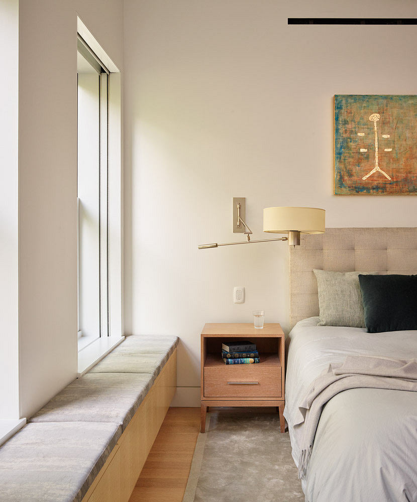 Contemporary bedroom with upholstered headboard, sleek side table, and wall-mounted