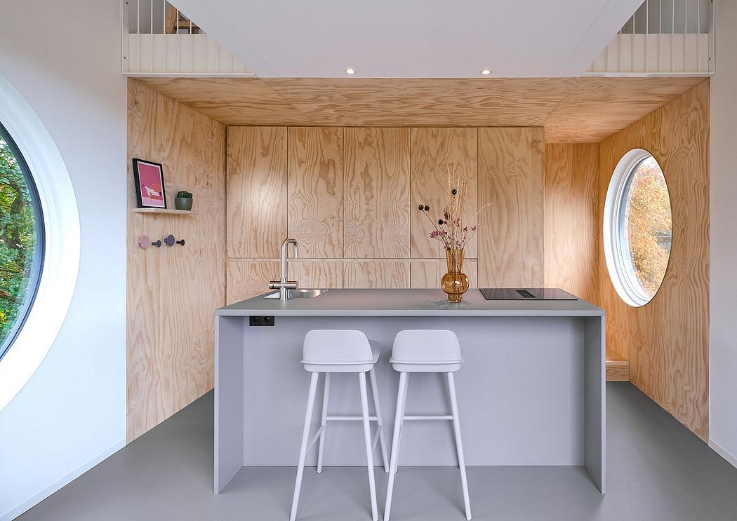 Minimalist kitchen with wood paneling and circular windows.