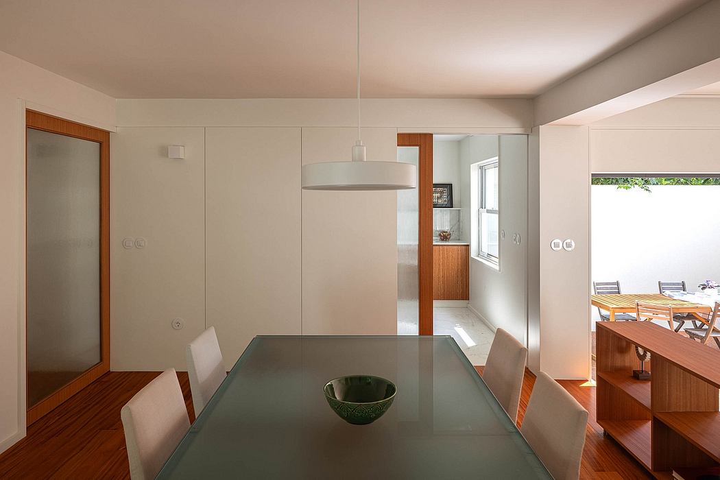 Contemporary dining room with a minimalistic design and glass table.