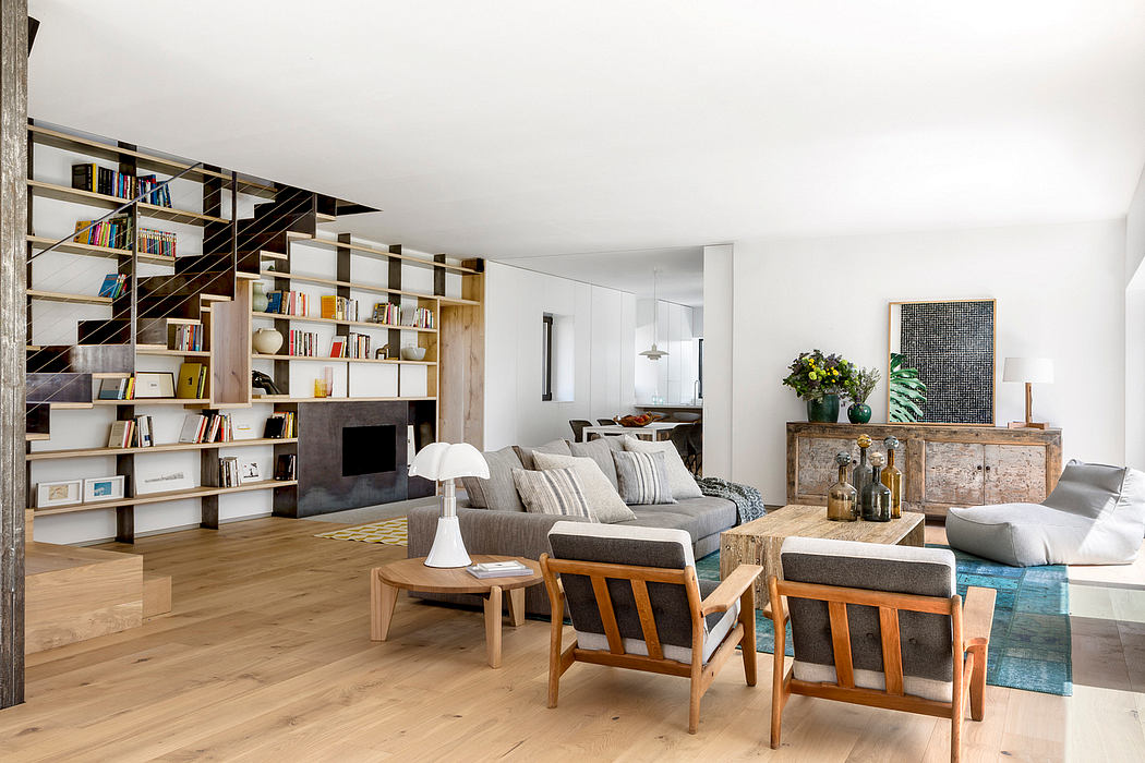 Modern living room with bookshelf, couch, and wooden floor.