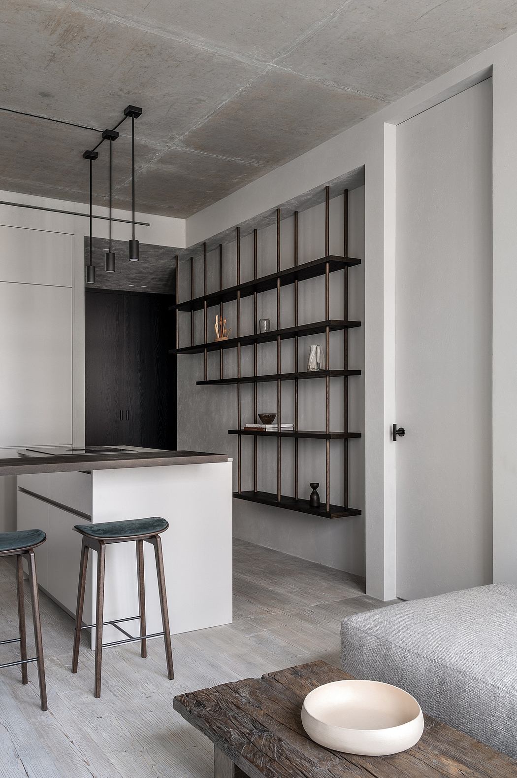 Minimalist kitchen with open shelving and gray tones.