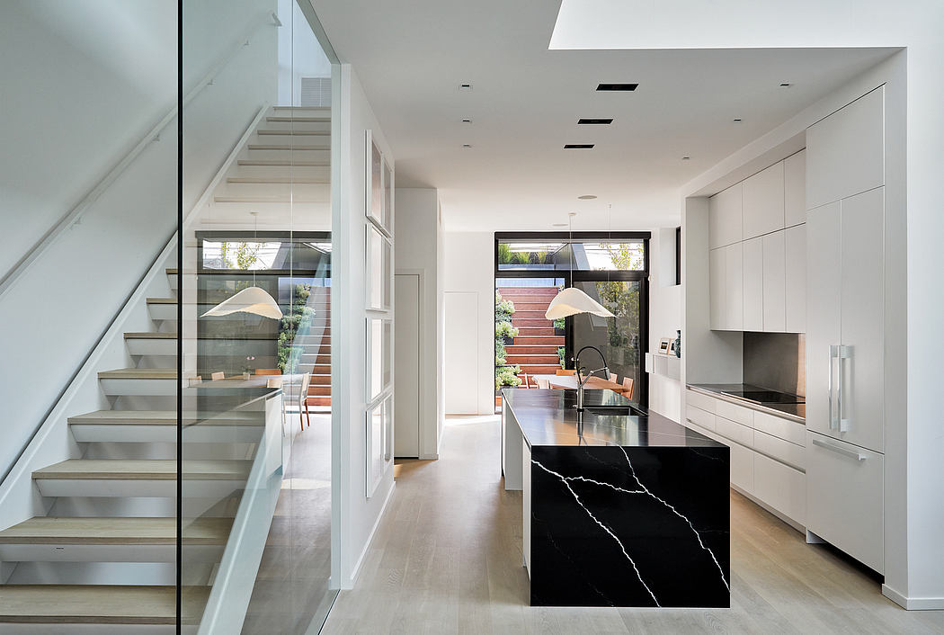 Modern kitchen interior with staircase and a view to the patio.
