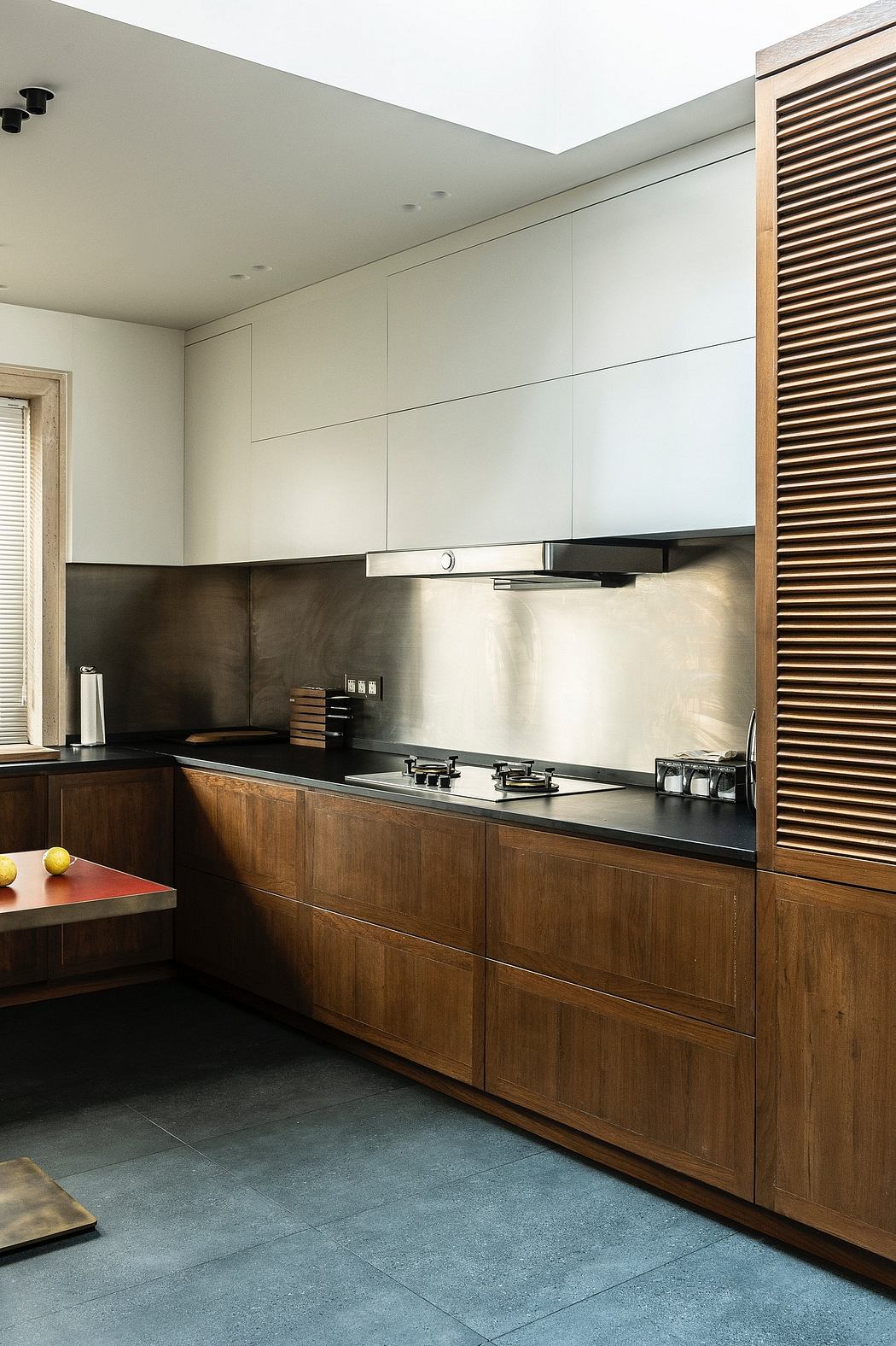 Contemporary kitchen with wooden cabinetry and stainless steel backsplash.
