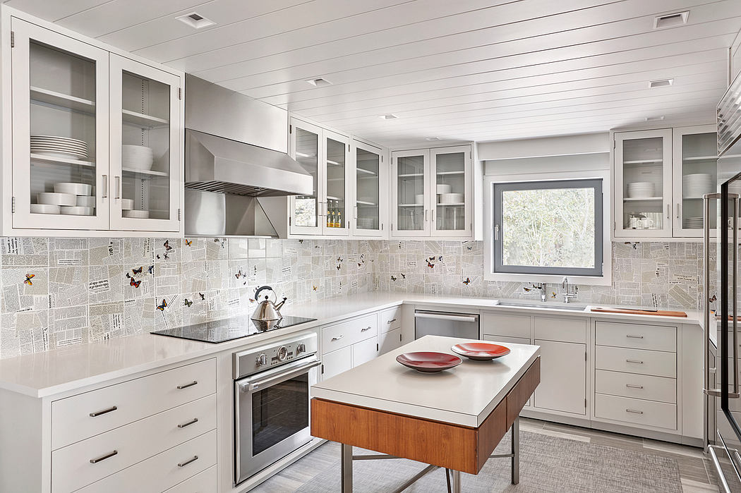 Bright, streamlined kitchen with white cabinetry and a central island.