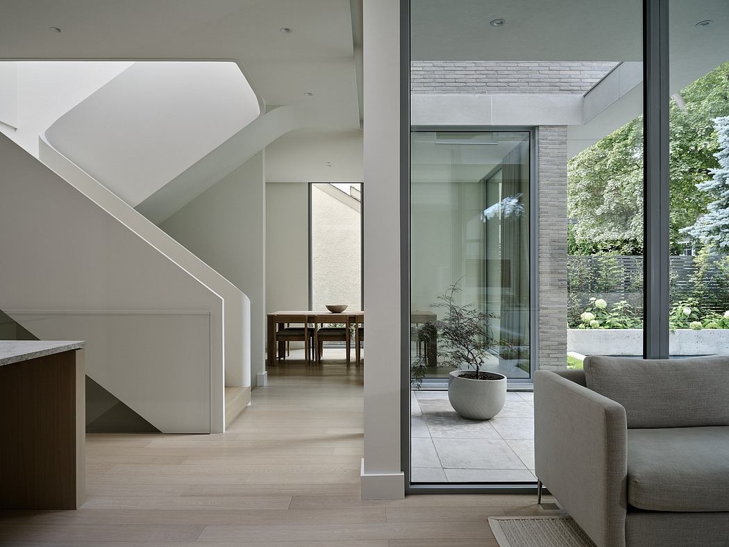 Contemporary interior with minimalist staircase and glass walls.