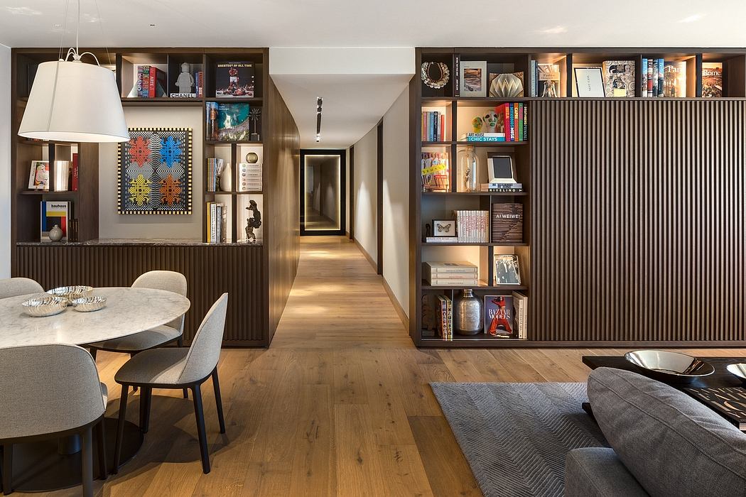 Contemporary dining area with bookshelves and wooden slatted walls.