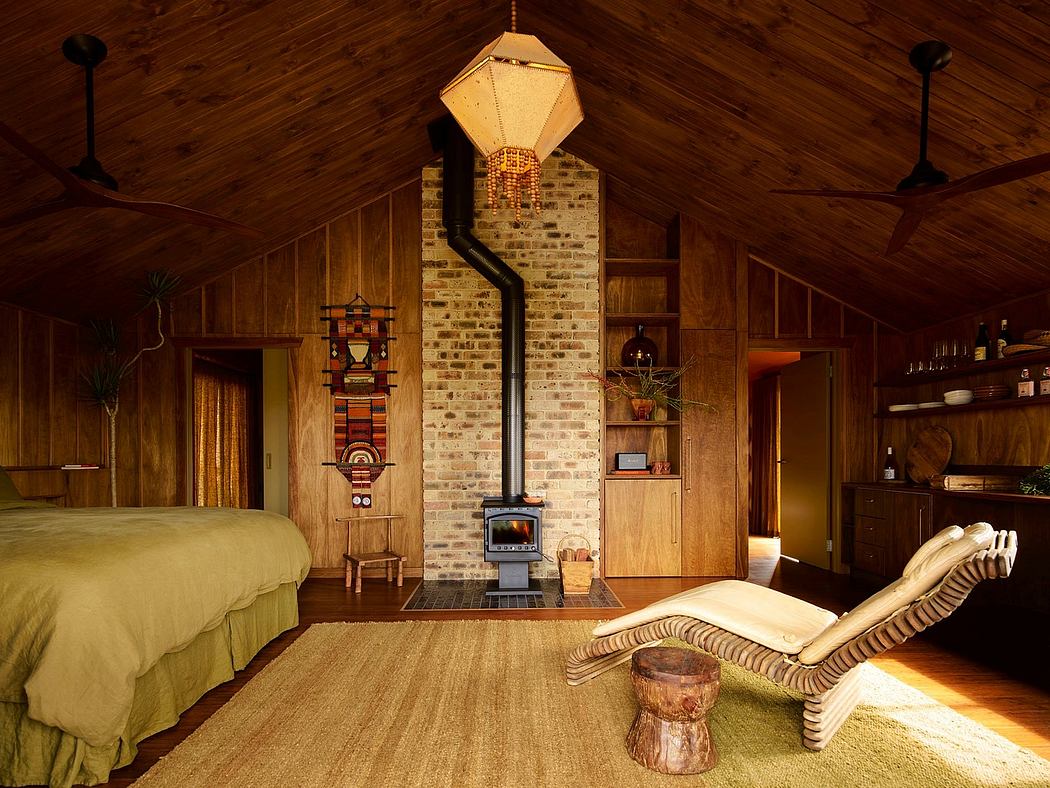 Rustic cabin interior with exposed beams and a wood stove.