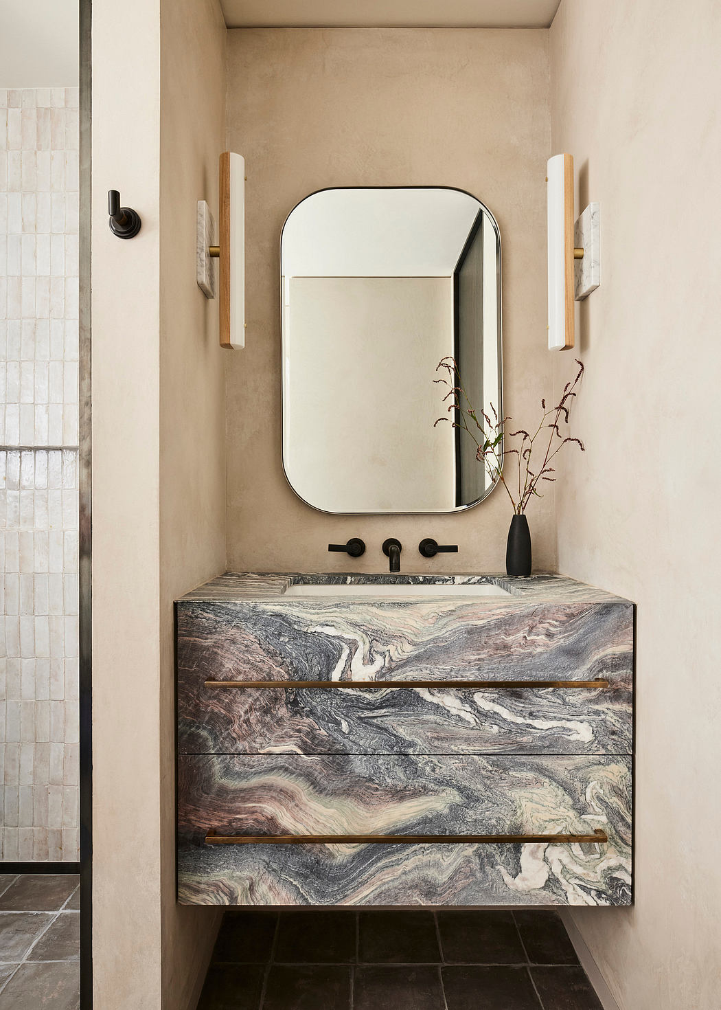 Modern bathroom with textured stone sink and rectangular mirror.