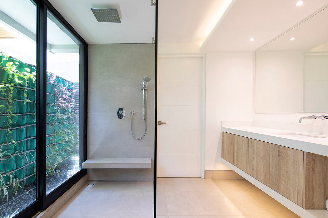 Modern bathroom with walk-in shower and large window beside a double vanity.