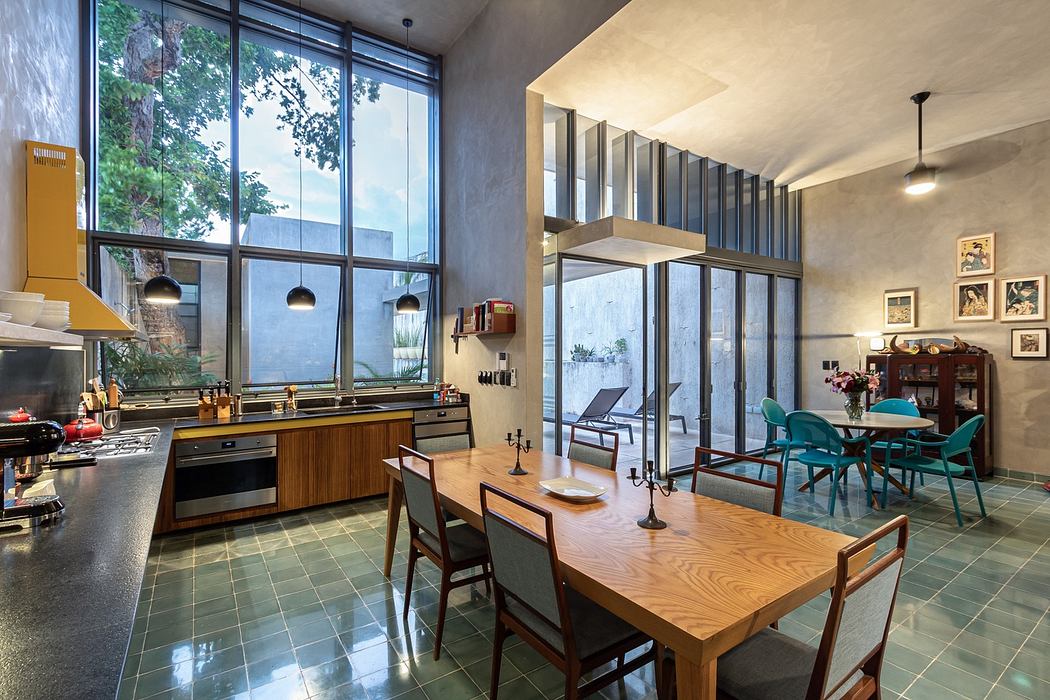 Modern kitchen with dining area, large windows, and concrete accents.
