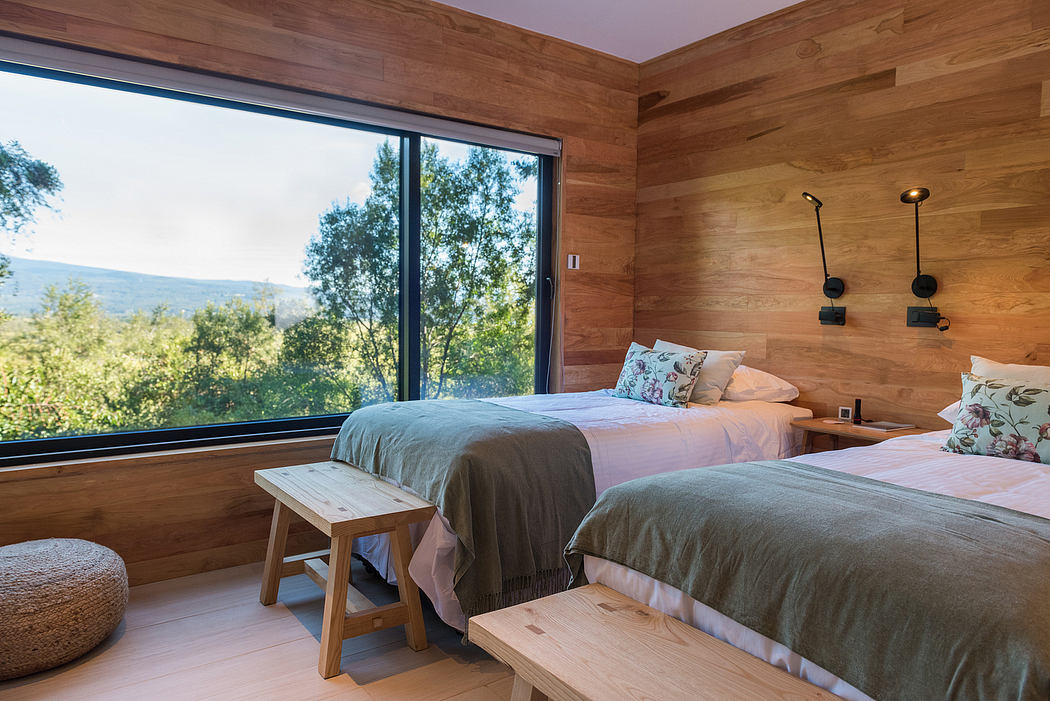 Wooden bedroom interior with large window and nature view.