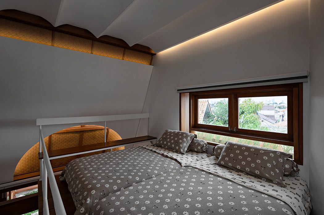 Cozy attic bedroom with a double bed and natural light from a window.