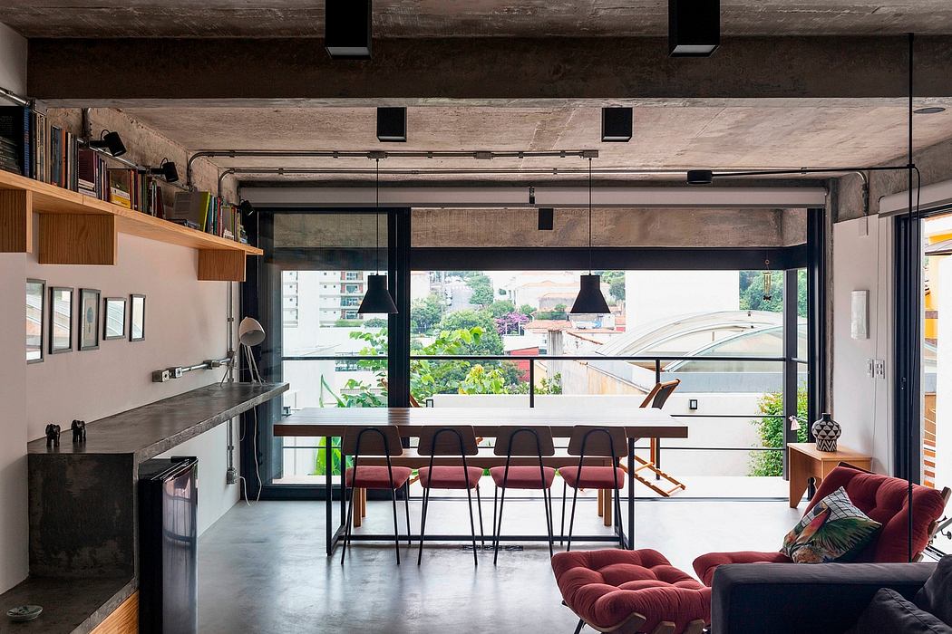 Industrial-style loft with exposed concrete, large windows, and open-plan living space.