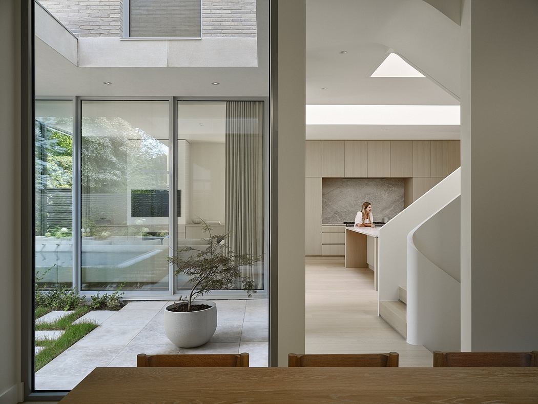 Modern home interior with large windows, open spaces, and a view to the garden