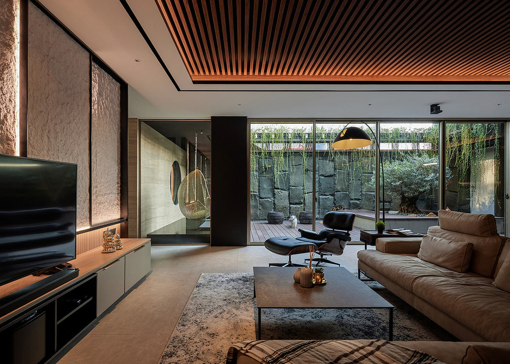 Modern living room with sleek furniture and a view of a garden.