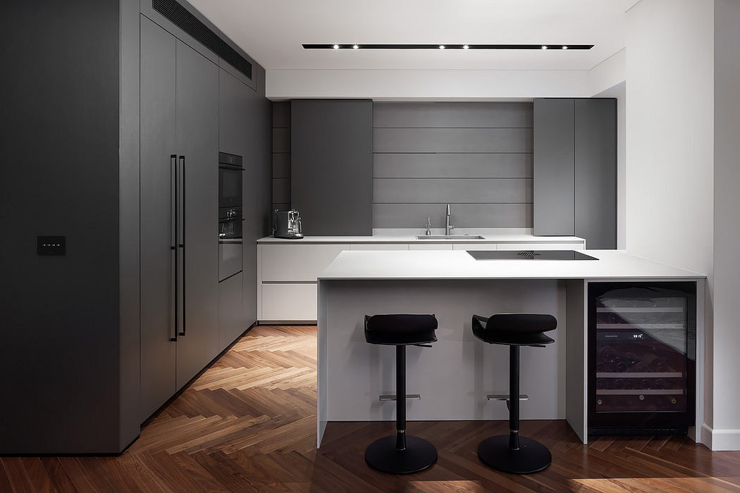 Modern kitchen with sleek grey cabinetry and a white island.