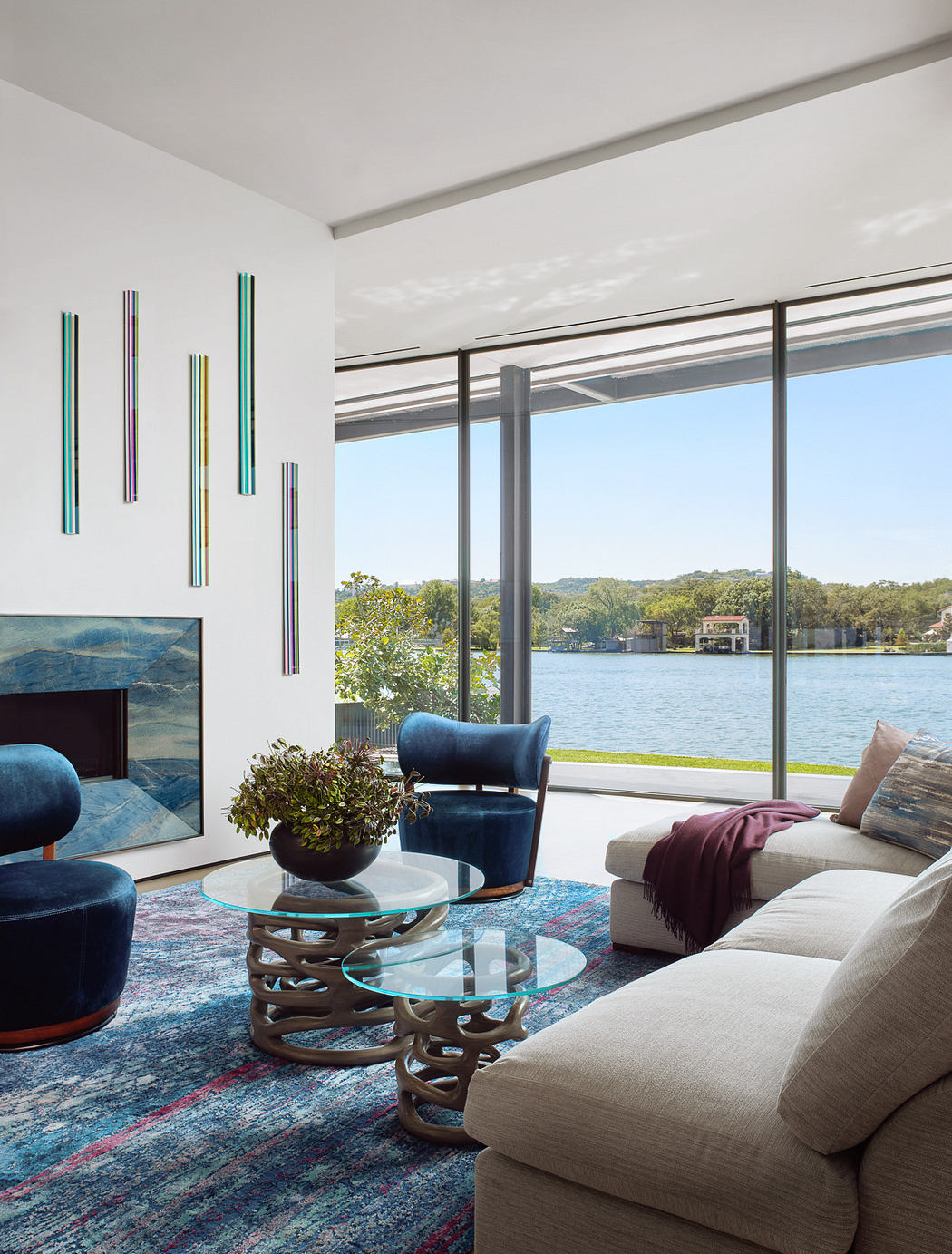 Modern living room with large window overlooking a lake.