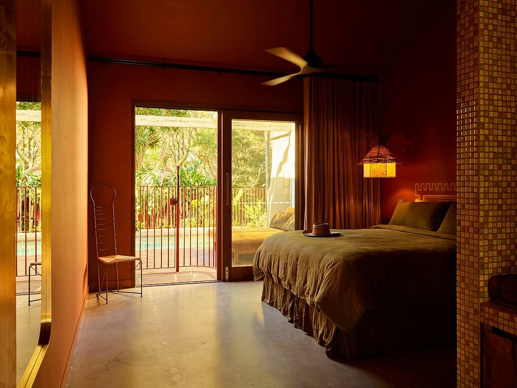 Warm-toned bedroom with sleek design, opening to a balcony.